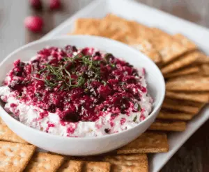 Cream Cheese Cranberry Dip served with fresh crackers and fruits for a festive appetizer.