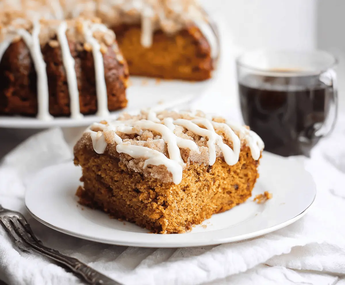 Delicious Pumpkin Cinnamon Coffee Cake with a moist crumb, topped with cinnamon swirl and icing drizzle, perfect for fall mornings