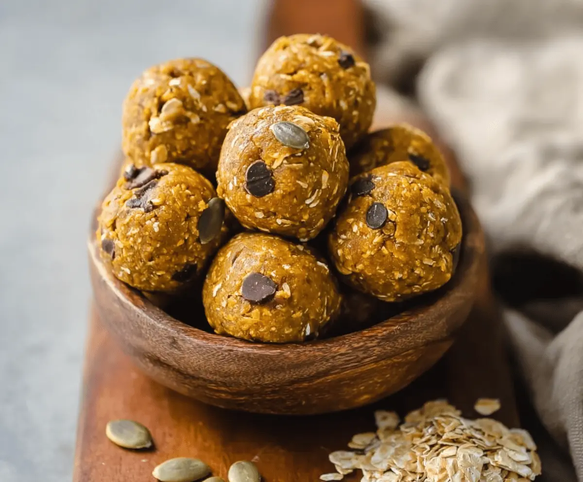 Healthy homemade pumpkin protein balls on a white plate, featuring pumpkin puree, oats, and protein powder for a nutritious snack