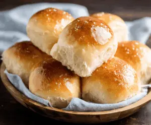 Delicious soft dinner rolls freshly baked with golden-brown crust and fluffy, airy interior, perfect for serving with any meal