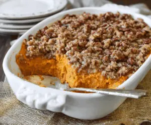 Baked sweet potato casserole topped with crunchy pecan streusel and marshmallows.
