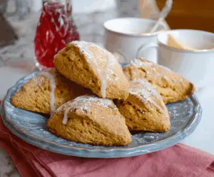 Golden-brown sweet potato scones fresh out of the oven, featuring a flaky, buttery texture and vibrant orange hue, perfect for breakfast or a snack.