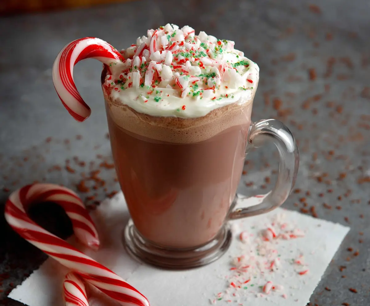 Creamy Candy Cane Hot Chocolate topped with whipped cream and crushed peppermint candies in a festive mug.