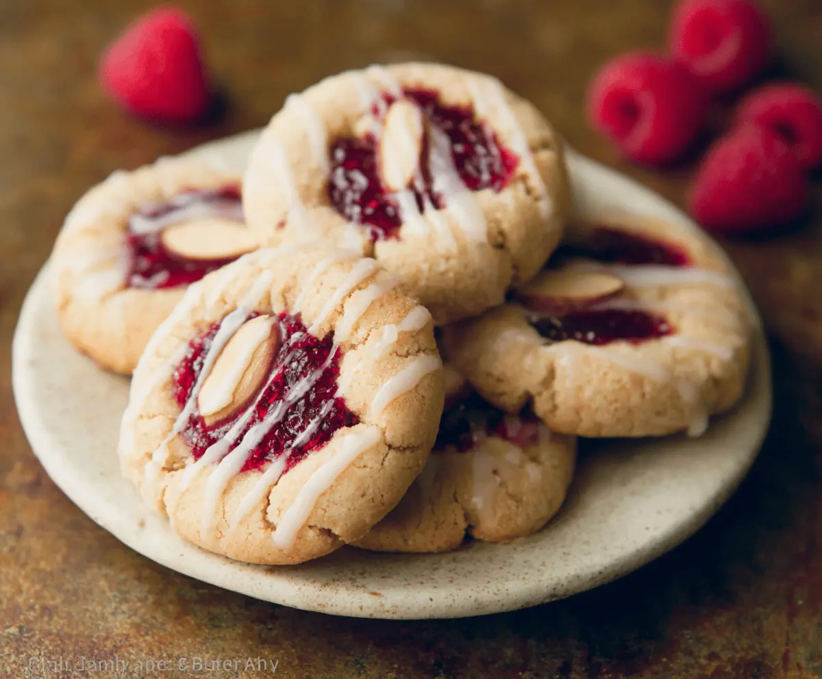 Delicious Raspberry Almond Butter Cookies on a wooden platter, showcasing vibrant red raspberries and golden almond butter cookies.