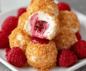 Delicious Raspberry Cheesecake Bites with creamy filling and fresh raspberries on top.