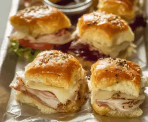 Delicious turkey and Swiss slider sandwiches served on a bun with melted cheese and fresh toppings.