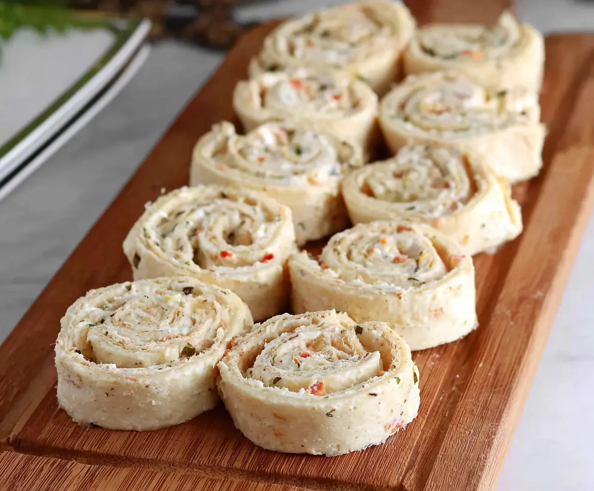 Delicious cream cheese pinwheels with flaky pastry and savory filling on a rustic wooden background
