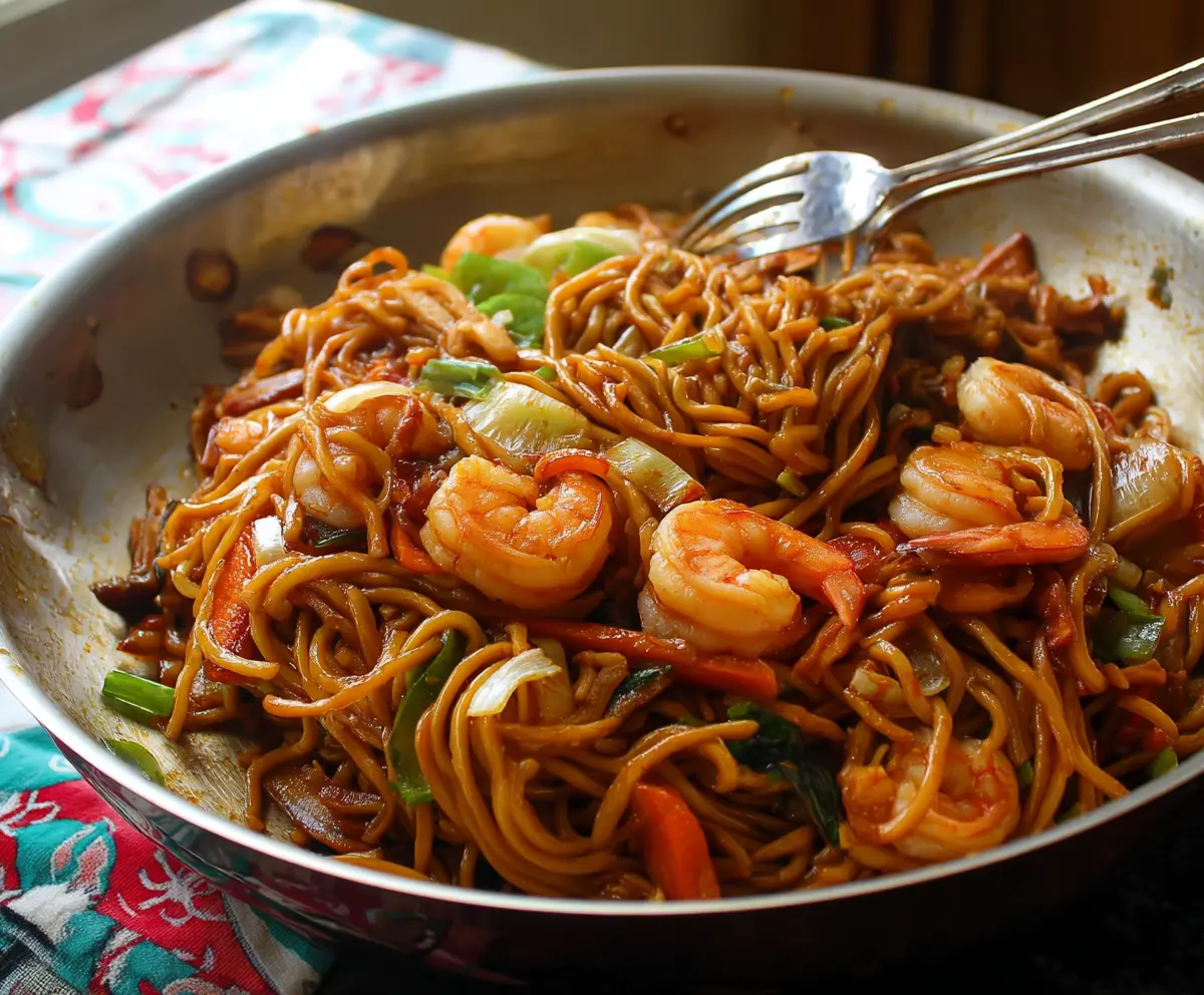 Delicious homemade Lo Mein with shrimp and fresh vegetables, served steaming hot.
