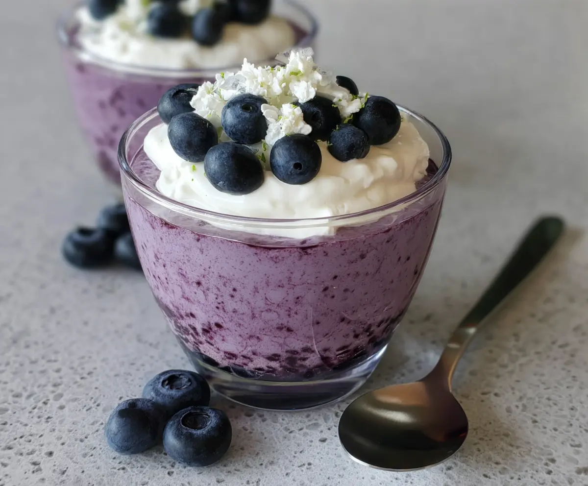 Delicious Blueberry Cottage Cheese Mousse served in a glass bowl, garnished with fresh blueberries and mint leaves.