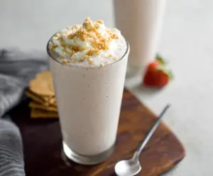 Healthy cottage cheese shake with fresh fruits and honey in a glass