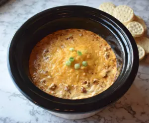 Creamy Crockpot Chili Cheese Dip served with tortilla chips, perfect for parties and snacks.