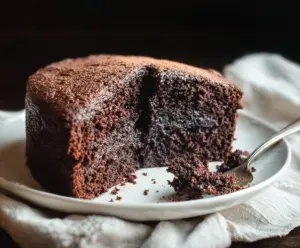 Delicious sourdough discard chocolate cake garnished with chocolate shavings and fresh berries.