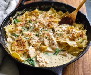 Delicious White Chicken Skillet Lasagna topped with melted cheese and fresh herbs.