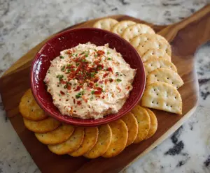 Spicy Alabama Fire Cracker Dip served with crackers and fresh vegetables ready to enjoy.