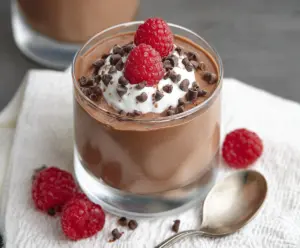 Delicious cottage cheese chocolate mousse served in a glass bowl, garnished with cocoa powder and chocolate shavings.