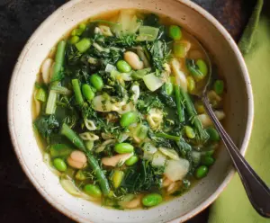 Fresh and vibrant Spring Green Minestrone Soup with seasonal vegetables in a bowl.