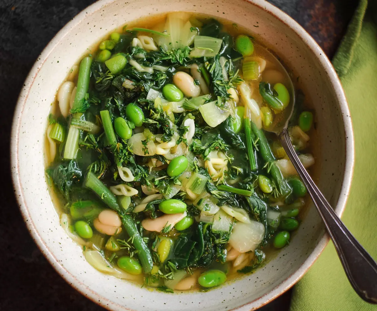 Fresh and vibrant Spring Green Minestrone Soup with seasonal vegetables in a bowl.