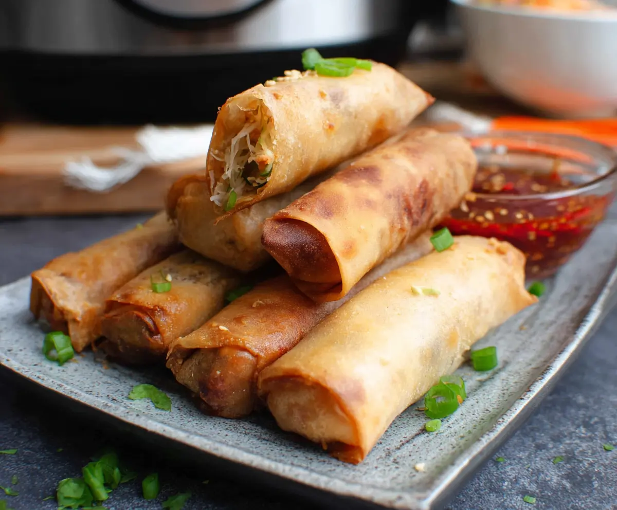 Crispy air fryer spring rolls filled with fresh vegetables and served with dipping sauce