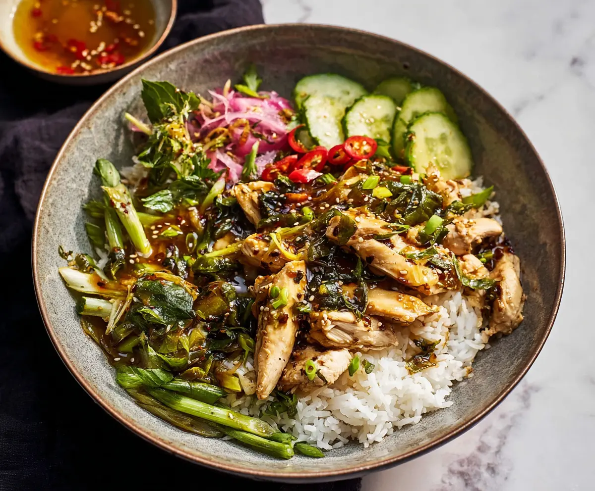 Delicious Ginger Scallion Chicken Bowl served with fresh vegetables and rice