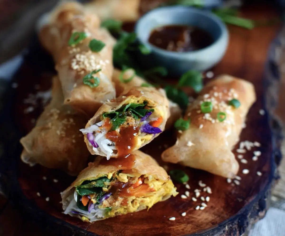 Delicious turmeric sesame chicken spring rolls filled with vibrant vegetables and herbs